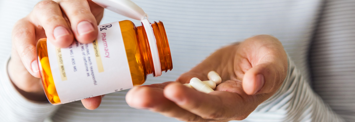 Person holding prescription medication bottle